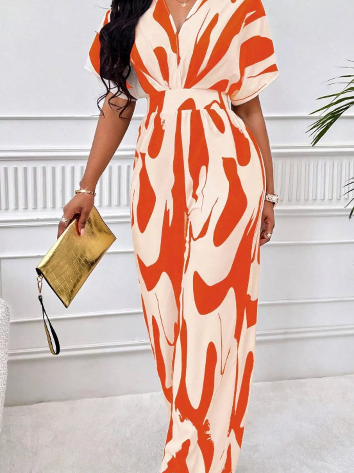 Abstract print wide-leg jumpsuit from Trendsi, featuring a stylish design, comfortable fit, and wide-leg silhouette.
