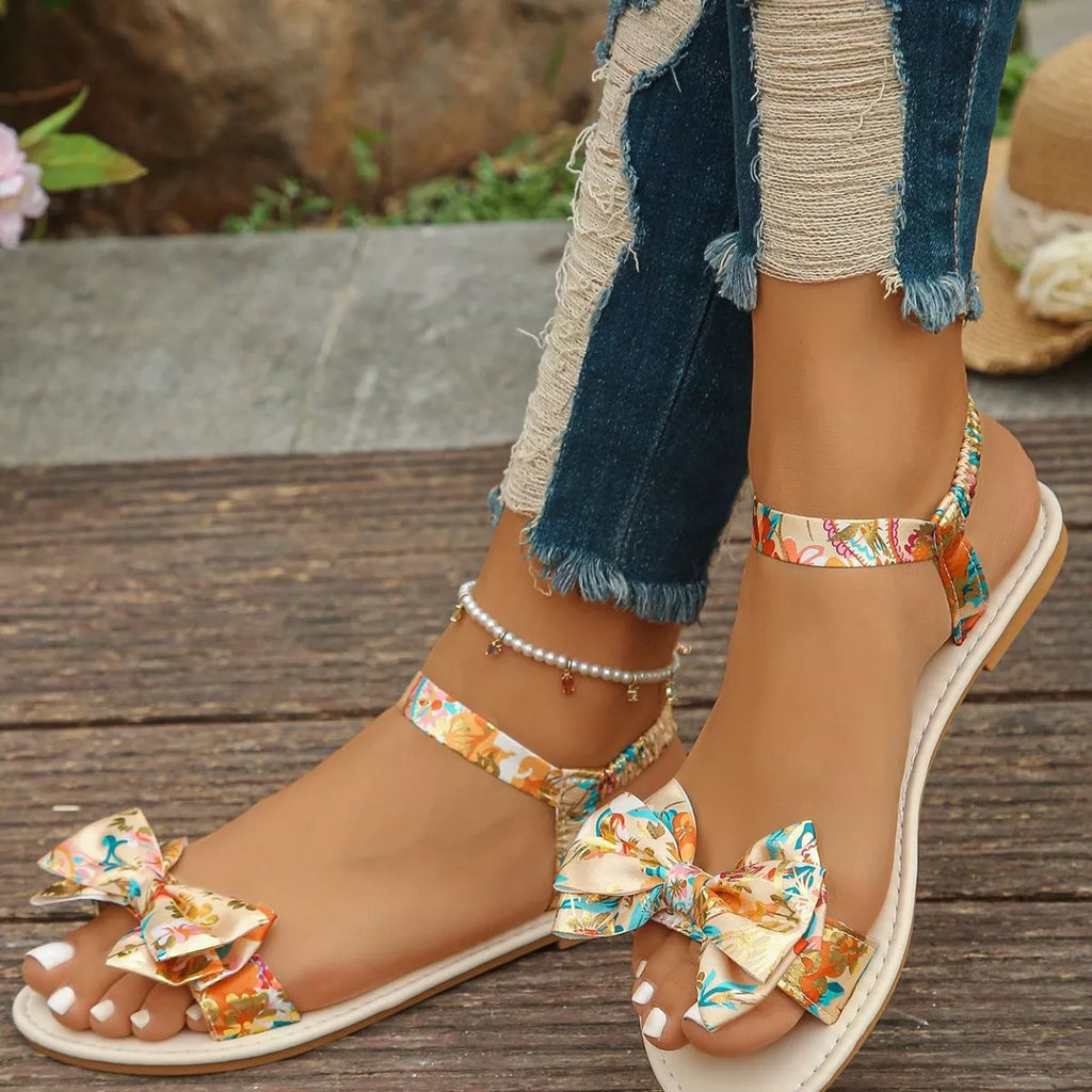 Trendsi floral bowknot ankle strap flat sandals for women, summer shoes with comfortable design and floral accents.