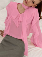 Elegant chiffon blouse with ruffle trim and tie neck detail, featuring flowy fabric and feminine design.