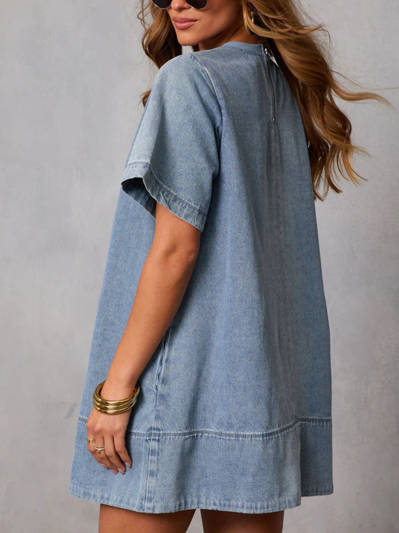Women's casual short sleeve denim dress with pockets from Trendsi, featuring a relaxed fit and classic denim blue fabric.