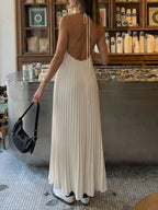 Elegant black halter neck maxi dress with pleated backless design by Trendsi, perfect for formal events.
