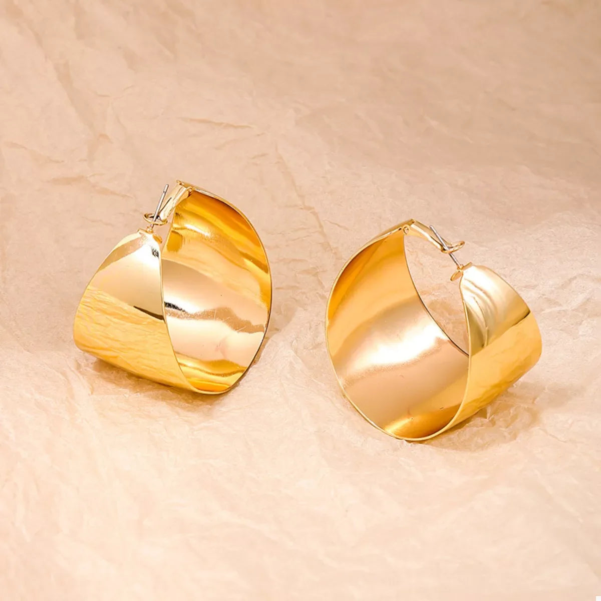 Plush Fashion Hub alloy wide hoop earrings with a shiny gold finish, showcasing their bold circular design and smooth surface.