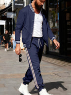 Men's plus size striped snap-down top and pants set by Trendsi, featuring a stylish full-length top and matching pants.