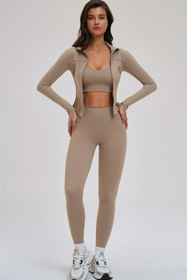 Fitglutes activewear three-piece set featuring a kinetic zip jacket, cross-back sports bra, and matching leggings for workouts.