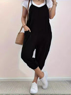 Casual loose fit spaghetti strap jumpsuit with pockets by Trendsi, styled for a relaxed, comfortable look.