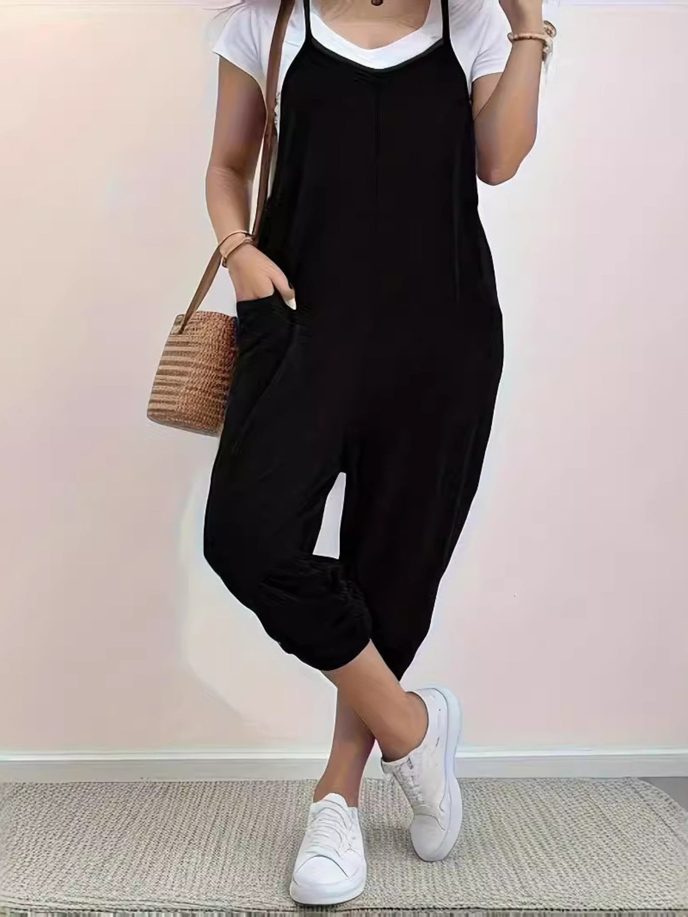 Casual loose fit spaghetti strap jumpsuit with pockets by Trendsi, styled for a relaxed, comfortable look.