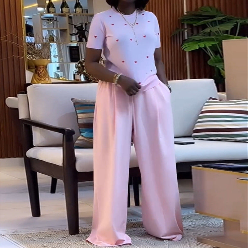 Heart print round neck top and wide-leg pants set by Plush Fashion Hub, featuring a cozy, stylish matching outfit with a playful design.
