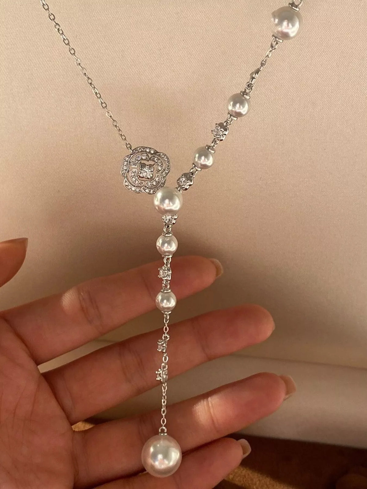 Pearl flower Y-necklace from Plush Fashion Hub featuring a elegant design with white pearls and floral accents.