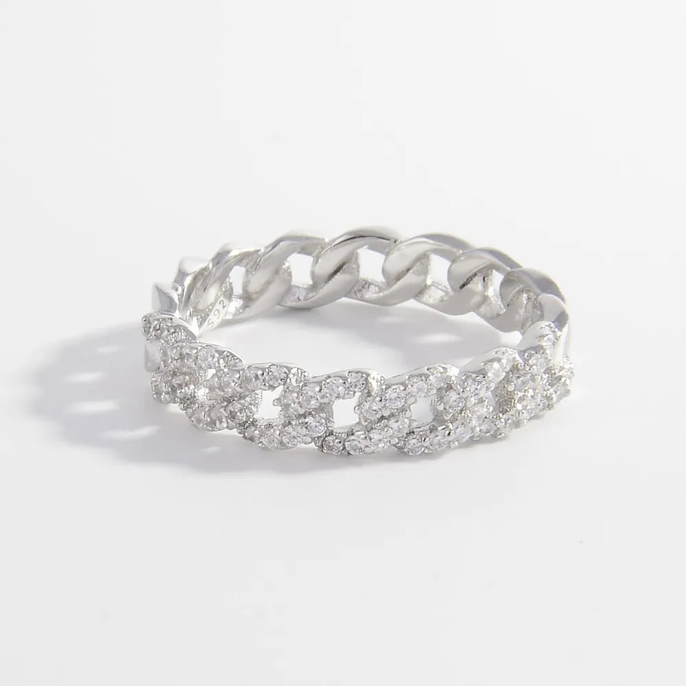 Sterling silver ring with inlaid zircon stones, featuring a polished band and intricate design, showcasing Shopimist jewelry craftsmanship.