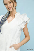 Umgee textured ruffle sleeve tiered midi dress displayed on a hanger, showcasing its flowy fabric and layered ruffle details.