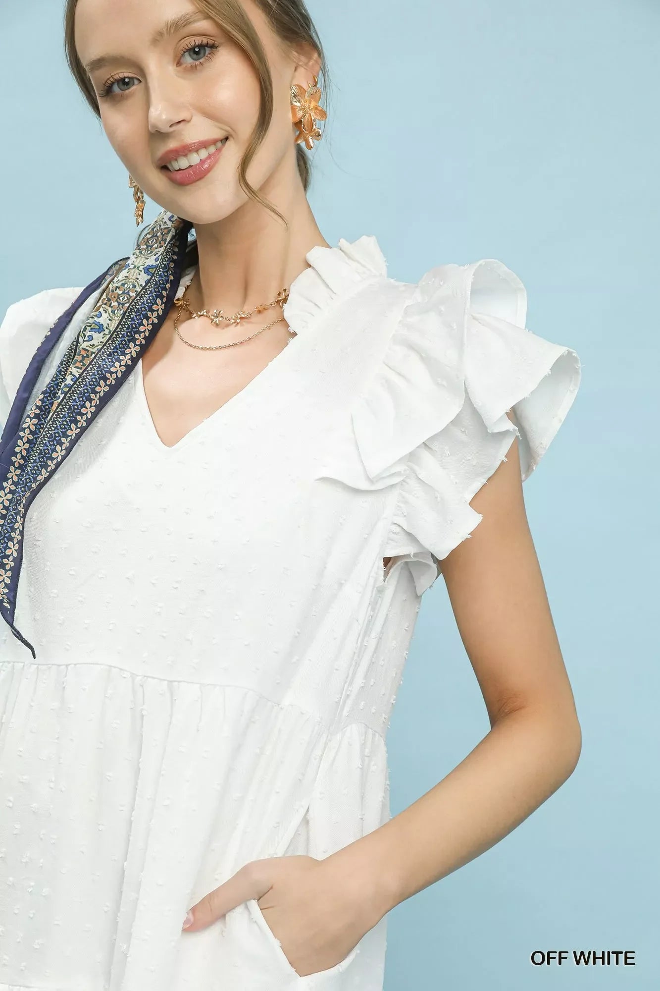 Umgee textured ruffle sleeve tiered midi dress displayed on a hanger, showcasing its flowy fabric and layered ruffle details.