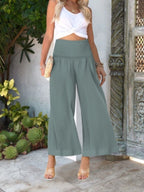 Women's lightweight wide-leg casual trousers with smocked waist, comfortable and stylish pants by Trendsi.