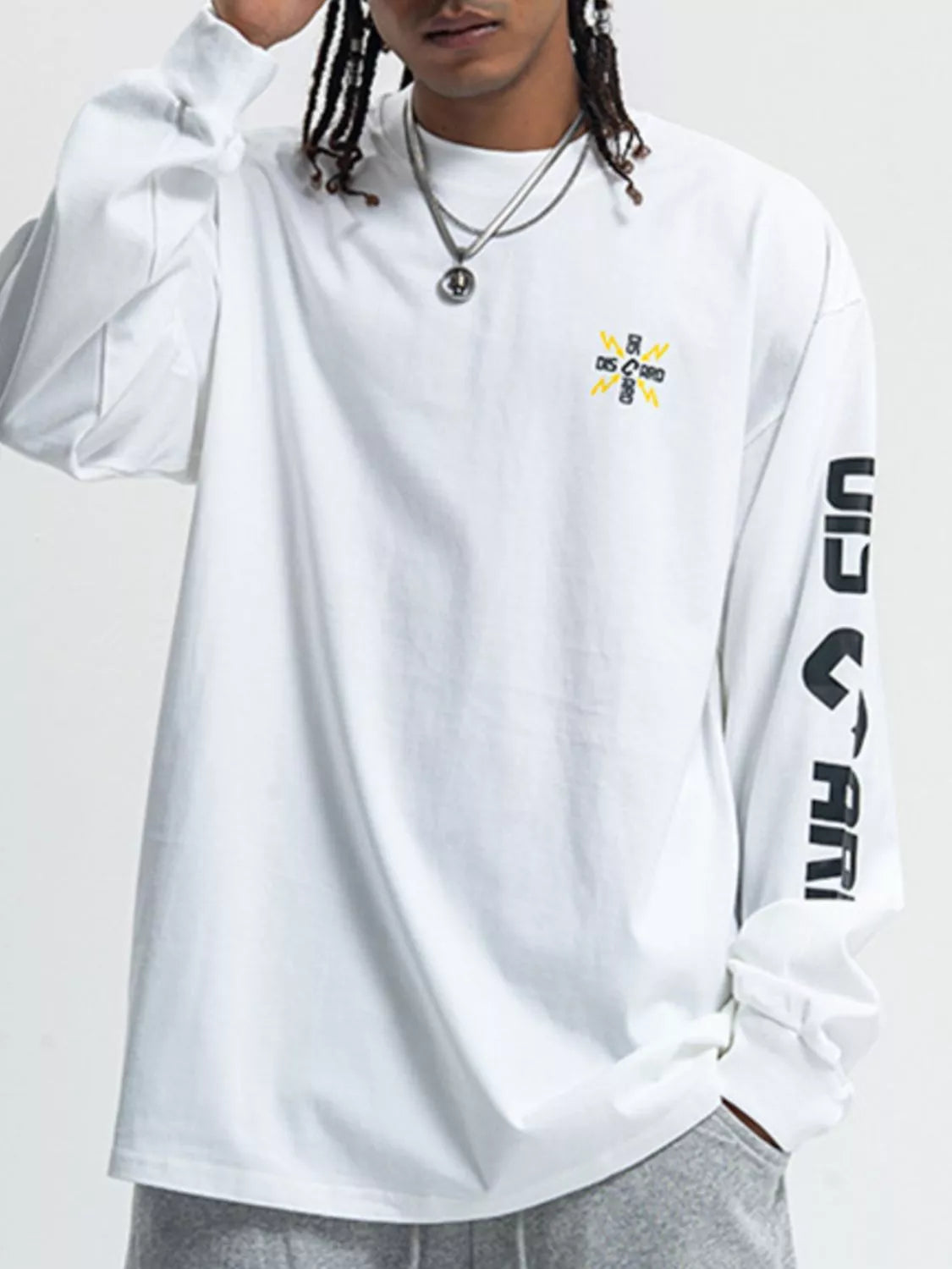 Men's round neck long sleeve T-shirt by Trendsi, shown in a neutral color, with a close-up of the fabric and fit.