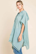 Women's cotton hooded beach cover-up dress with tassel hem by Trendsi, featuring a relaxed fit and casual style.