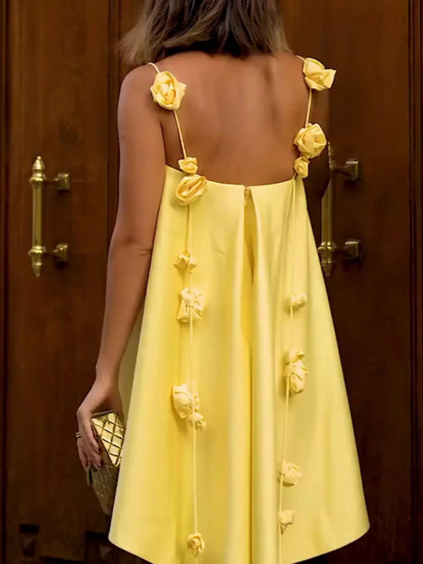 Floral strap mini A-line dress by Trendsi featuring a fitted bodice and flowy skirt, perfect for casual summer outings.