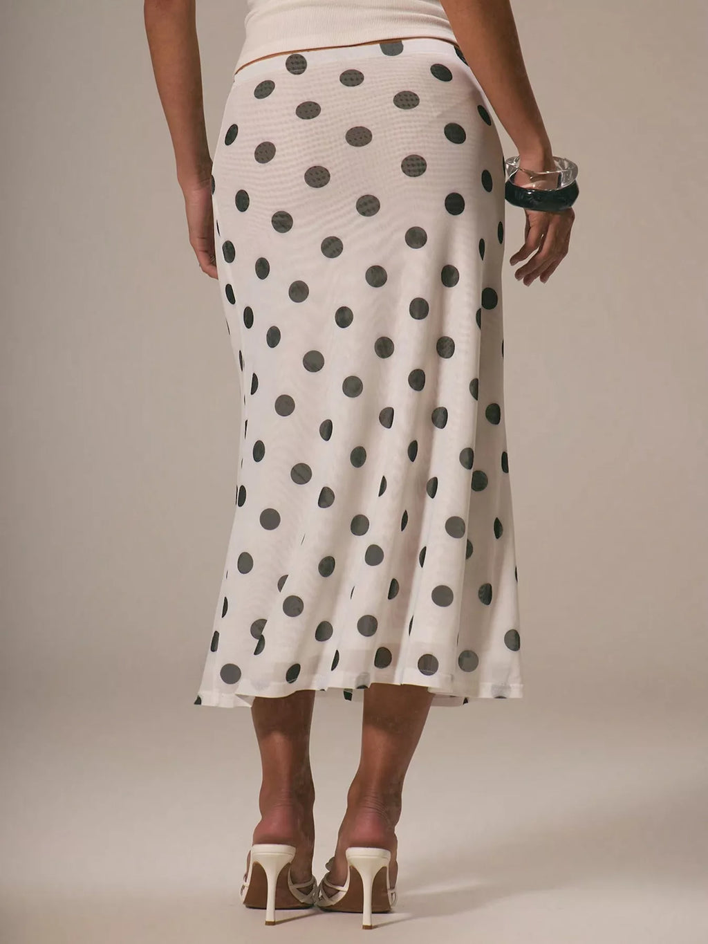 Women's vintage-inspired polka dot midi skirt with high waist and A-line silhouette, stylish women's apparel from Trendsi.