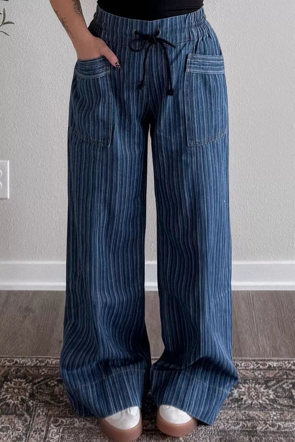 Striped wide-leg denim jeans from Plush Fashion Shop, featuring a relaxed fit and bold stripe pattern on soft blue denim fabric.