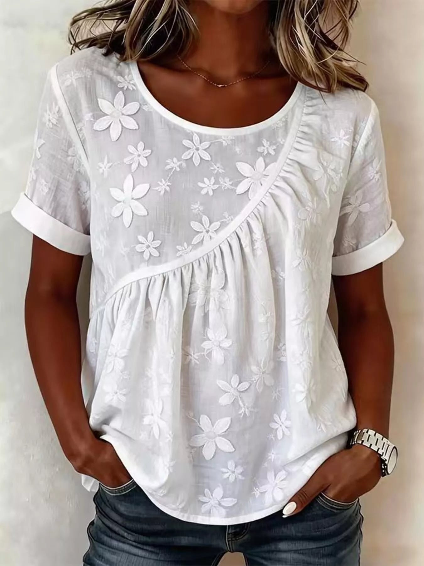 Plus size floral embroidered round neck short sleeve top by Trendsi, featuring colorful floral embroidery on a comfortable fit blouse.