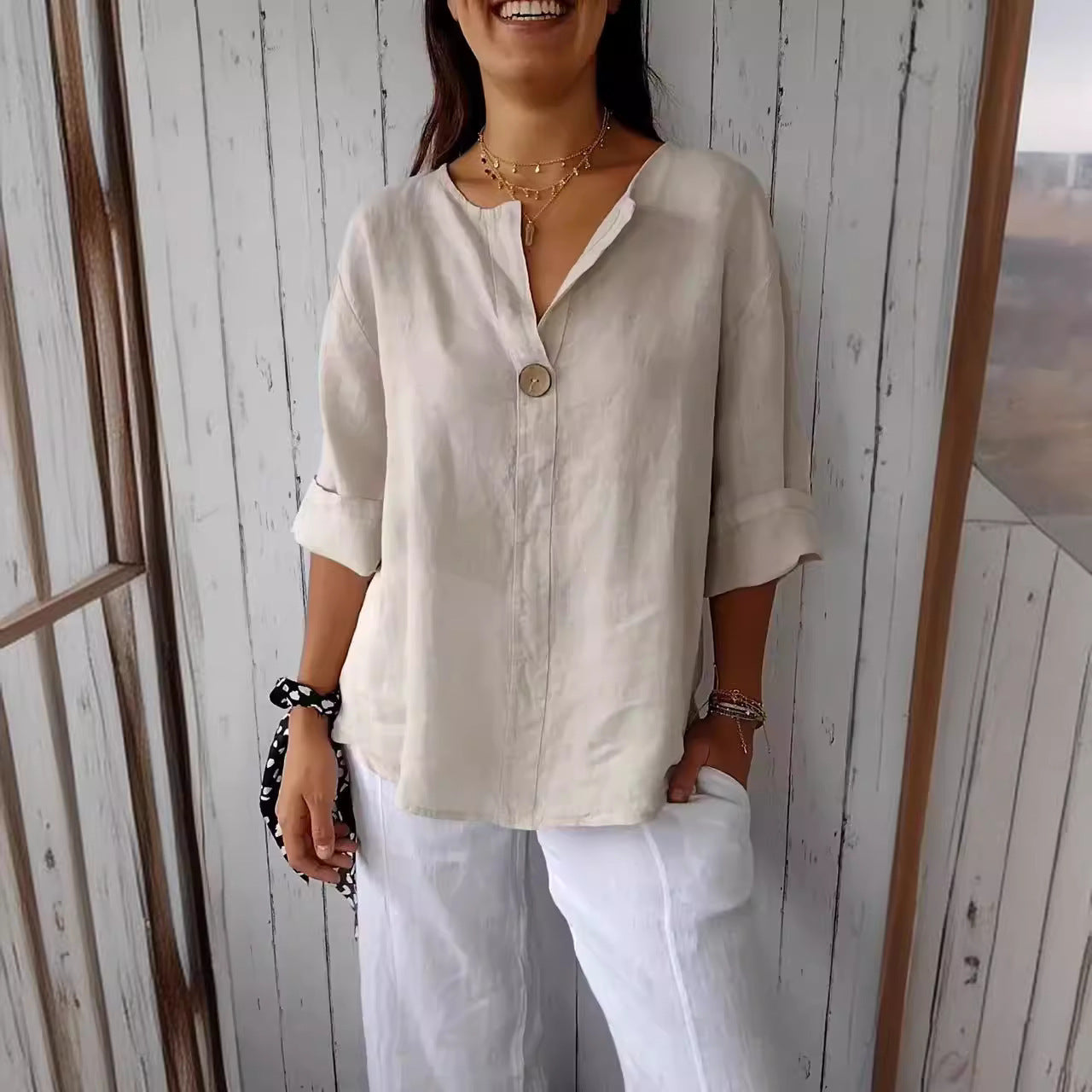 Women's loose fit V-neck long-sleeve button top by FitiqueFit, casual blouse shown in a relaxed, stylish fit.