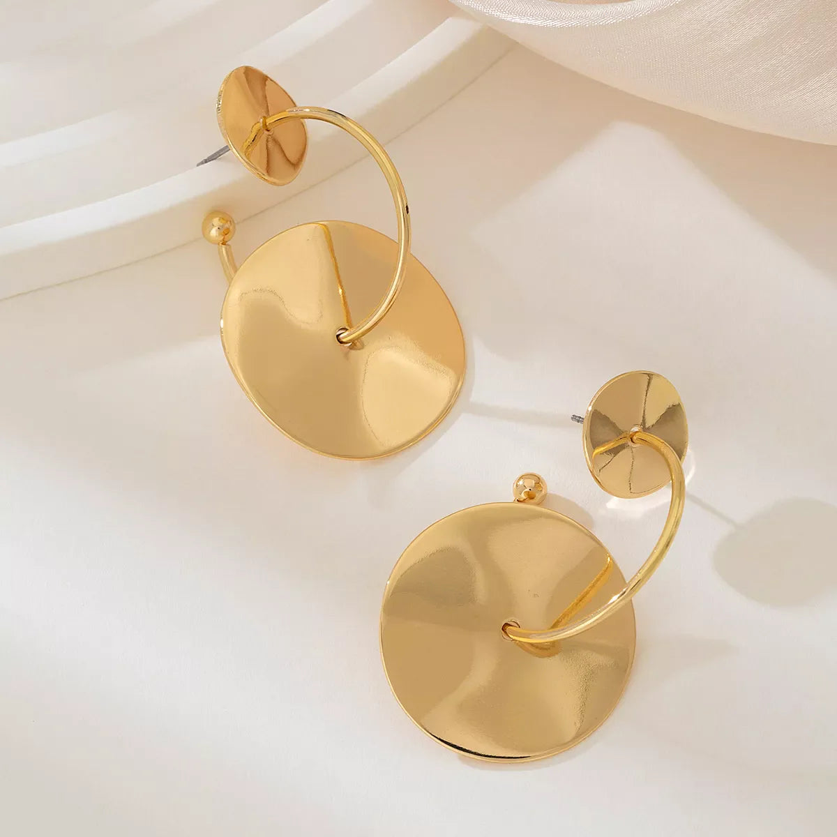 Gold-plated geometric circle drop earrings from Plush Fashion Hub, featuring modern design with sleek, polished finish.