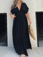 Plus size maxi dress with slit V-neck, smocked waist, full-length design, by Trendsi, featuring flowing fabric and elegant style.