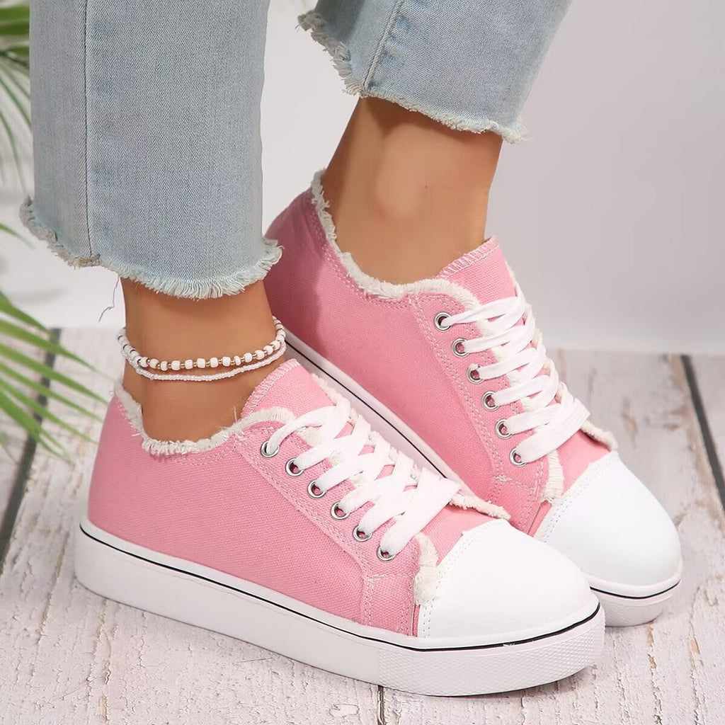 Lightweight women's lace-up canvas sneakers with flat sole and low-top design from Plush Fashion Hub.