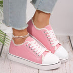 Lightweight women's lace-up canvas sneakers with flat sole and low-top design from Plush Fashion Hub.