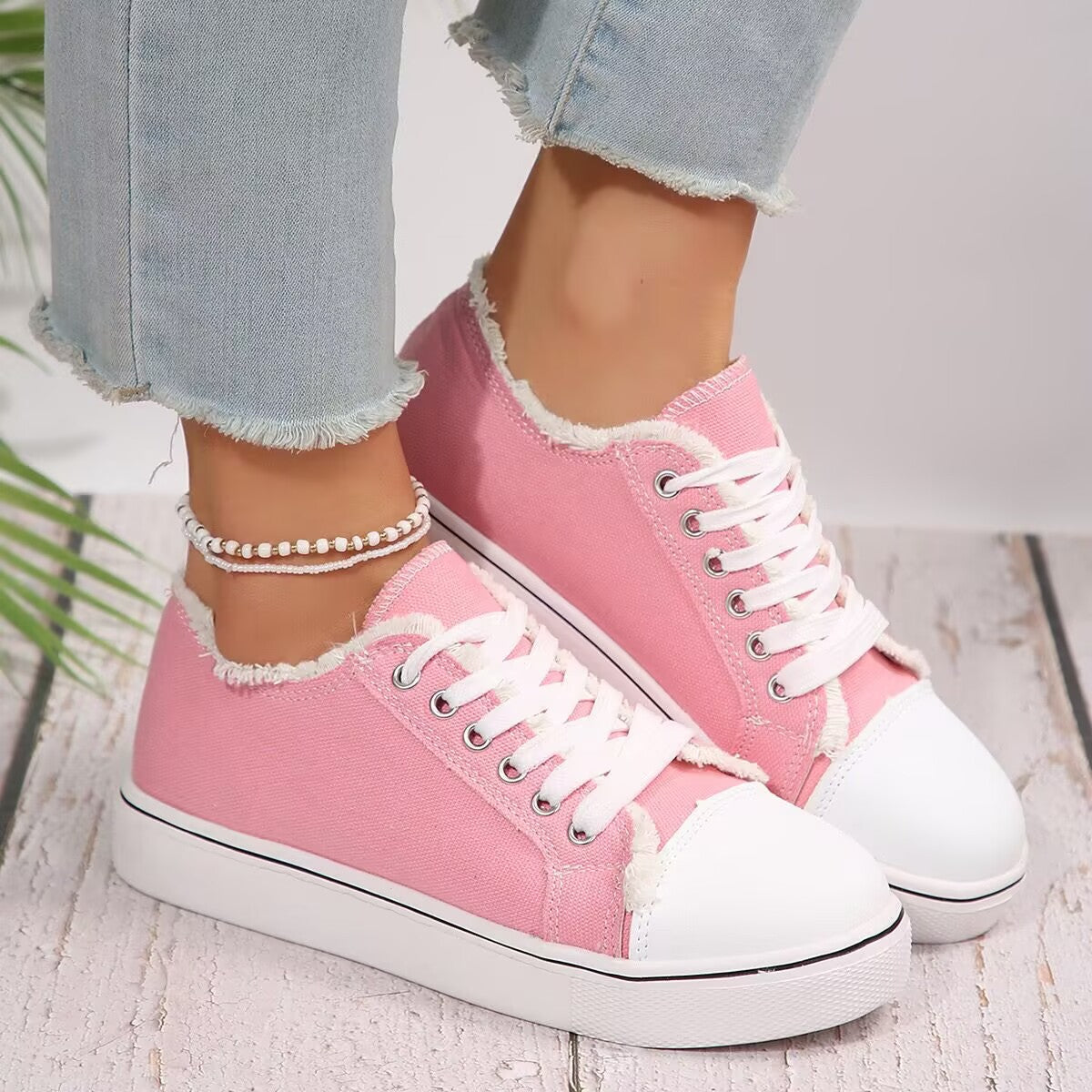 Lightweight women's lace-up canvas sneakers with flat sole and low-top design from Plush Fashion Hub.