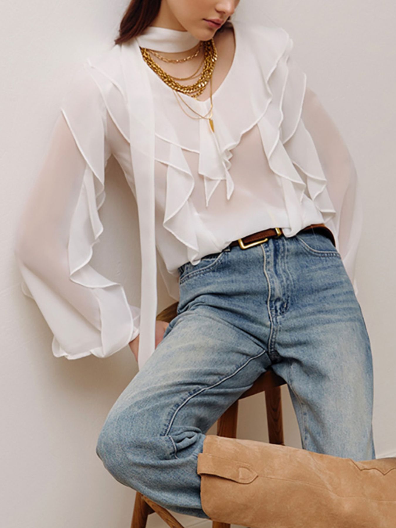 Elegant chiffon blouse with ruffle trim and tie neck detail, featuring a flowy fabric and stylish design.