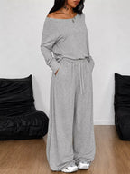 Plus size loose fit one-shoulder t-shirt and pants set by Trendsi, featuring comfortable, relaxed fit fabric and stylish design.