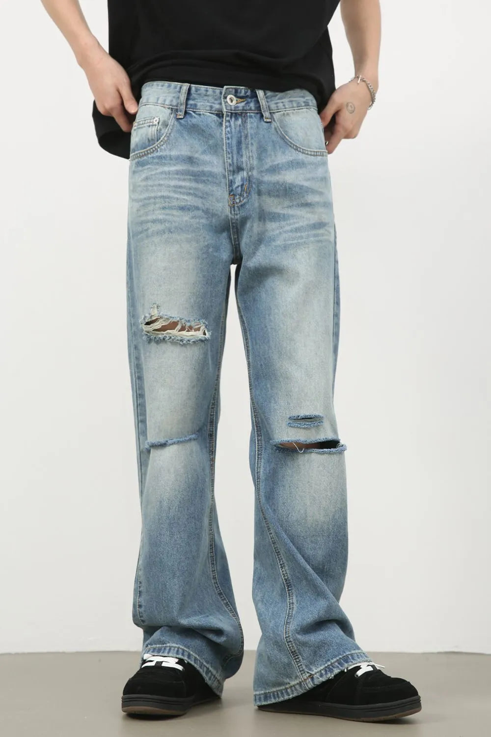 Men's distressed denim jeans by Plush Fashion Shop, showing a casual fit with frayed details and a classic blue wash.