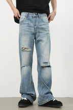 Men's distressed denim jeans by Plush Fashion Shop, showing a casual fit with frayed details and a classic blue wash.
