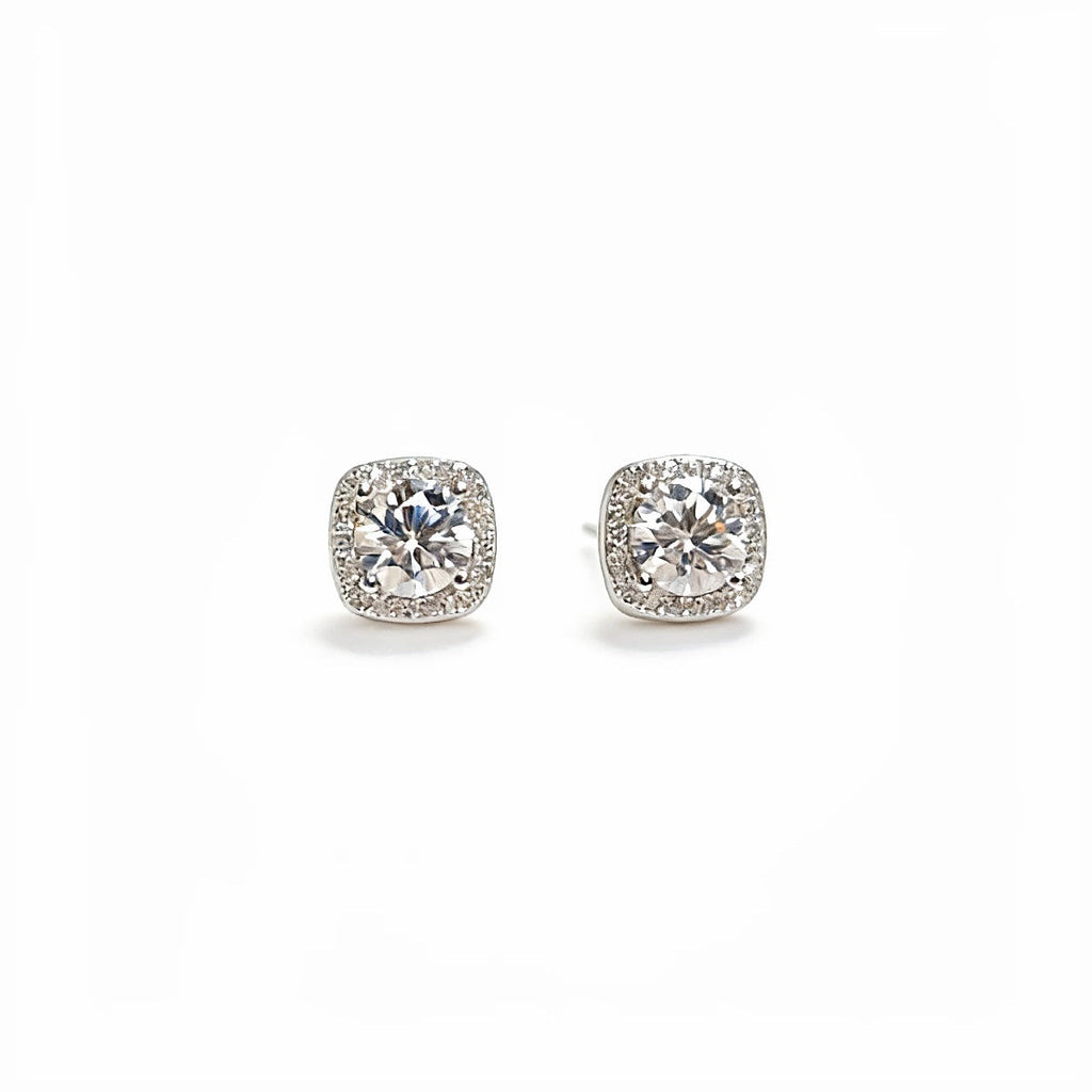 Sterling silver stud earrings with 1 carat moissanite gemstones, showcasing sparkling, round-cut jewelry from Shopimist.