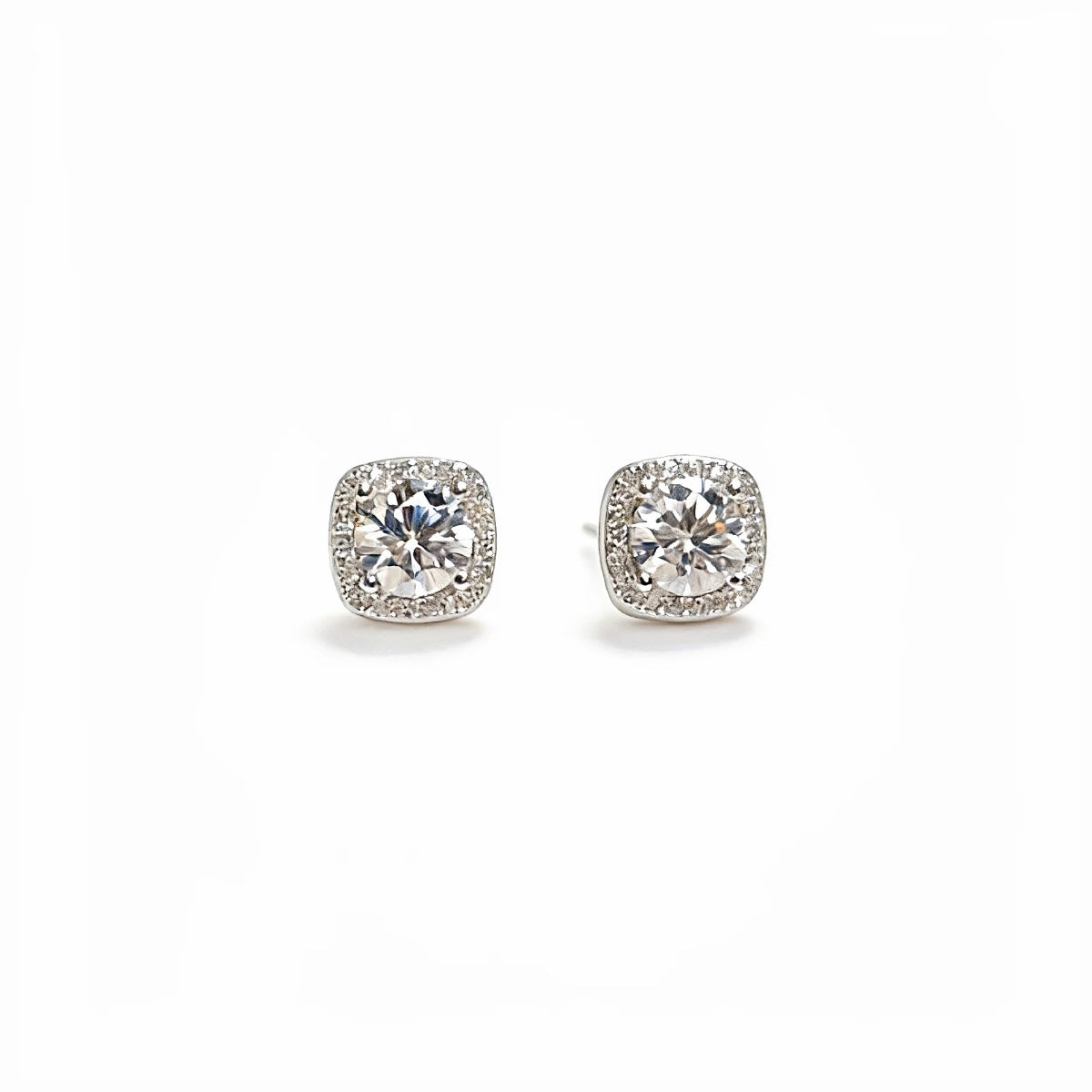 Sterling silver stud earrings with 1 carat moissanite gemstones, showcasing sparkling, round-cut jewelry from Shopimist.