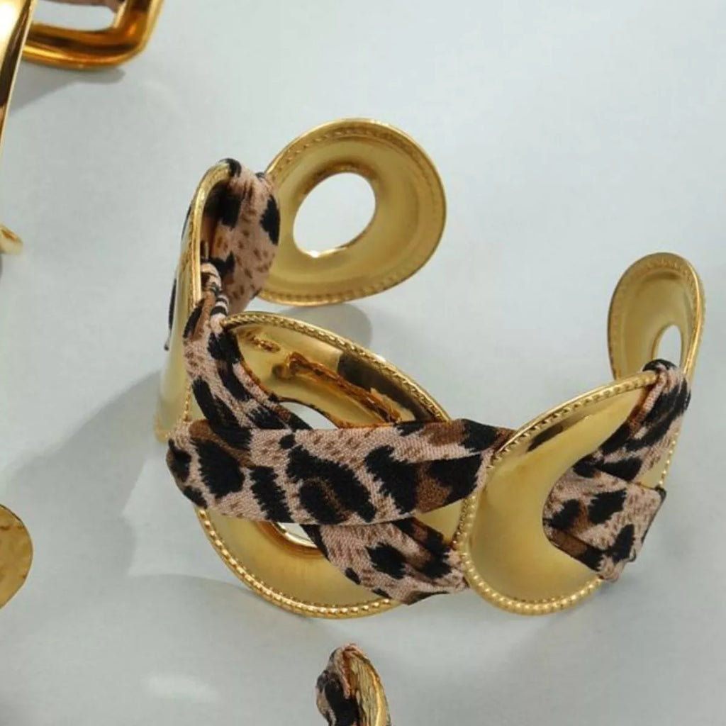 Leopard ribbon 18K gold-plated open bracelet with a sleek, stylish design featuring a leopard pattern and gold finish.
