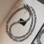 Shopimist pearl choker necklace with white pearls and silver clasp, close-up view of elegant jewelry on a plain background.