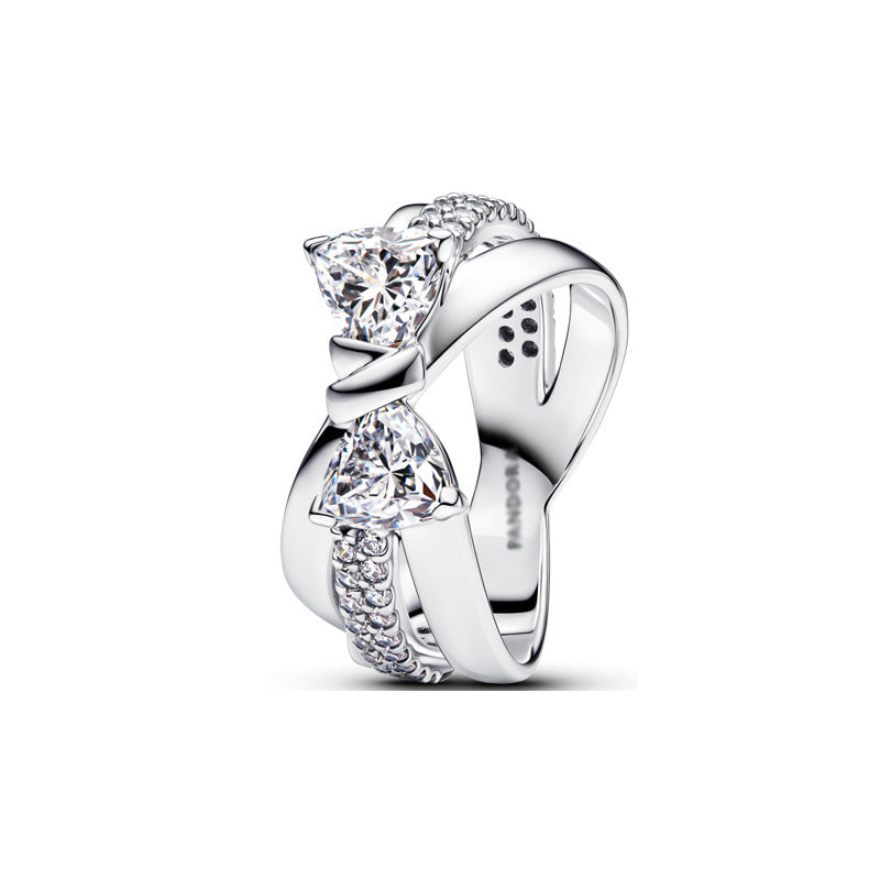 Silver split-shank ring featuring two trillion-cut stones and pavé accents.