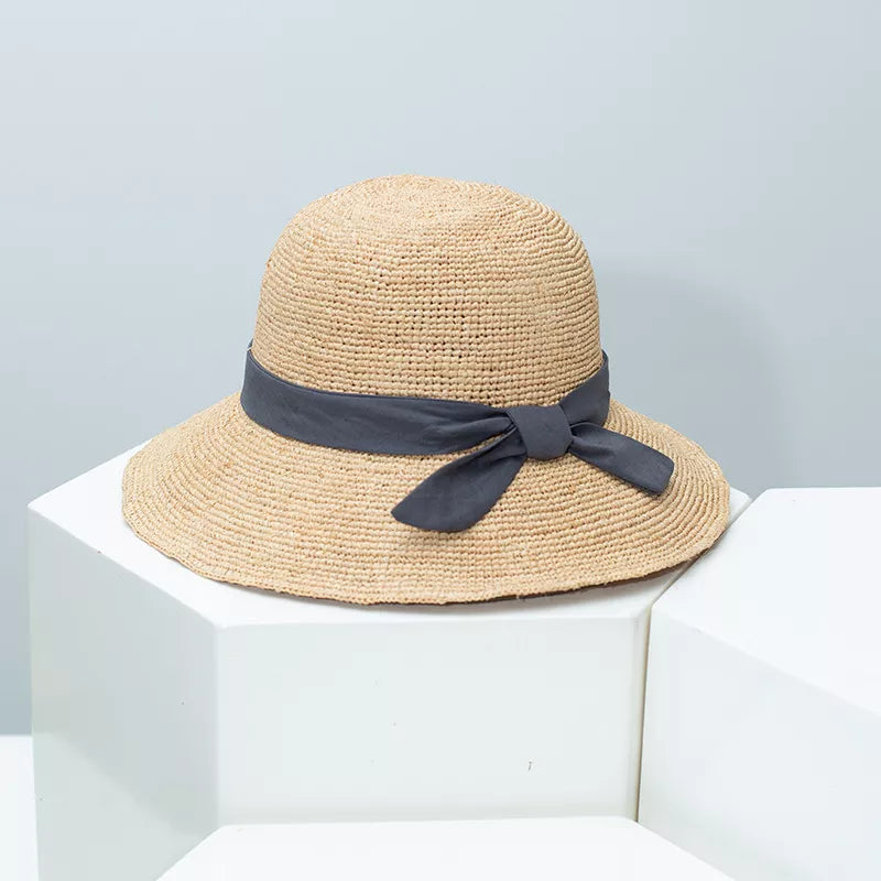 Women's straw sun hat with wide brim and ribbon detail, stylish summer accessory from Plush Fashion Hub