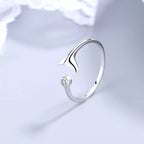 Sterling silver whale tail ring by Shopimist featuring a detailed, polished design on a smooth band.