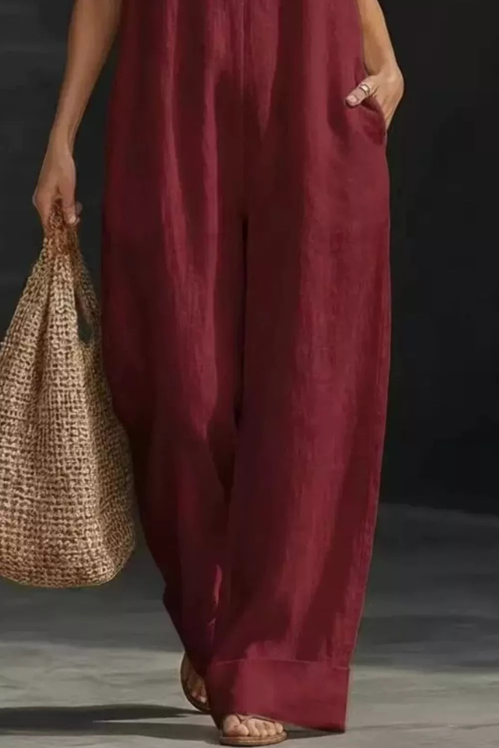 Women's sleeveless wide-leg jumpsuit with pockets, casual chic romper by Trendsi, shown in a stylish, relaxed fit.