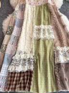 Boho patchwork lace-trimmed A-line tiered dress with flowy fabric and bohemian style, featuring intricate patchwork and lace details.