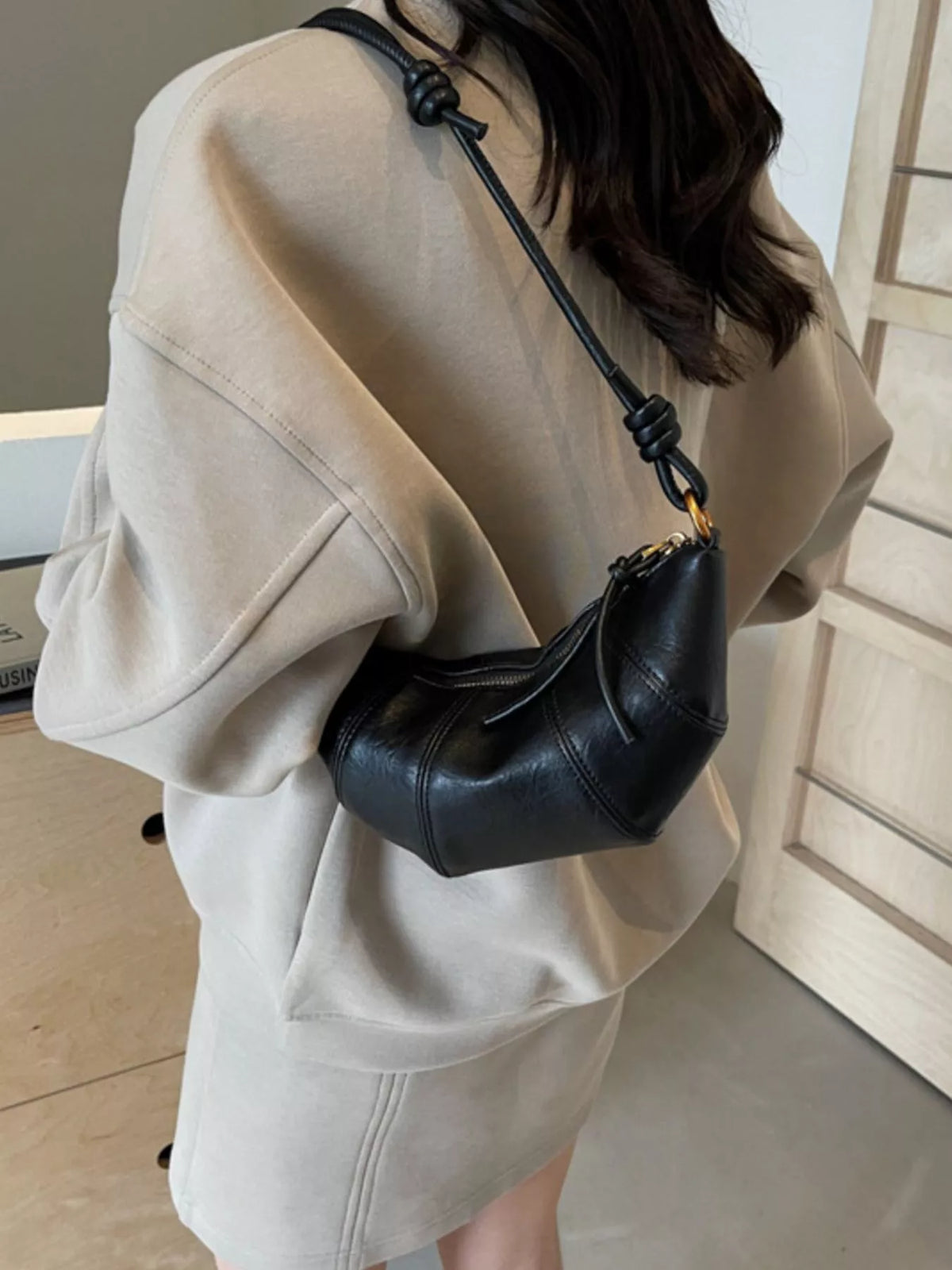 Plush Fashion Hub croissant-shaped crossbody bag in soft plush material, featuring a detailed croissant design and adjustable strap.