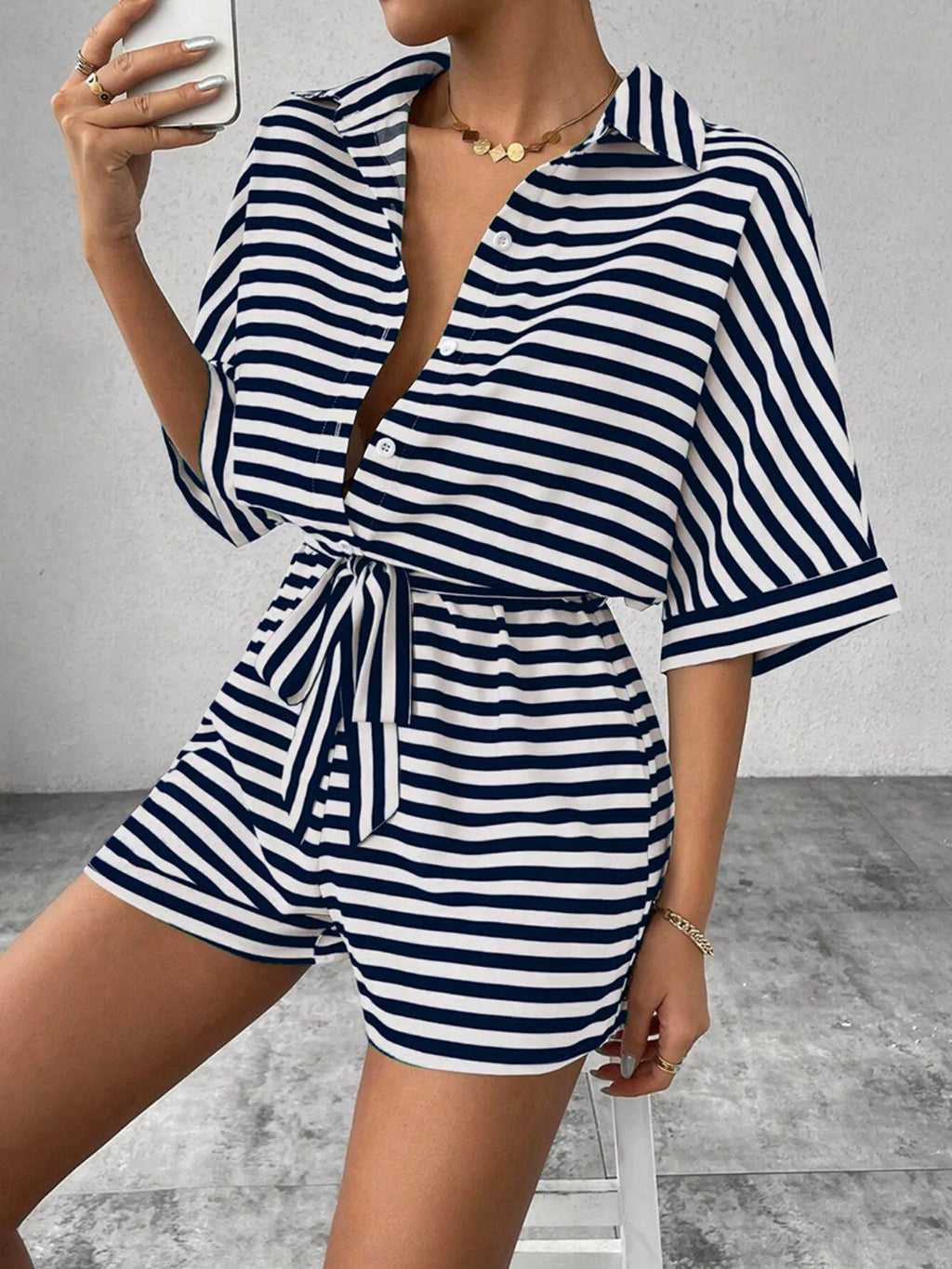 Striped button-front half sleeve romper shirt by Plush Fashion Hub displayed on a hanger.
