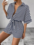Striped button-front half sleeve romper shirt by Plush Fashion Hub displayed on a hanger.