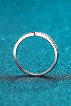 Rhodium-plated Moissanite ring featuring sparkling gemstones and a sleek band, designed for elegant jewelry wear.