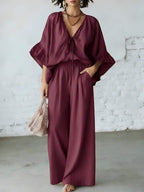 Casual women's two-piece set with loose-fit V-neck top and wide-leg pants from Plush Fashion Hub, shown on a hanger.