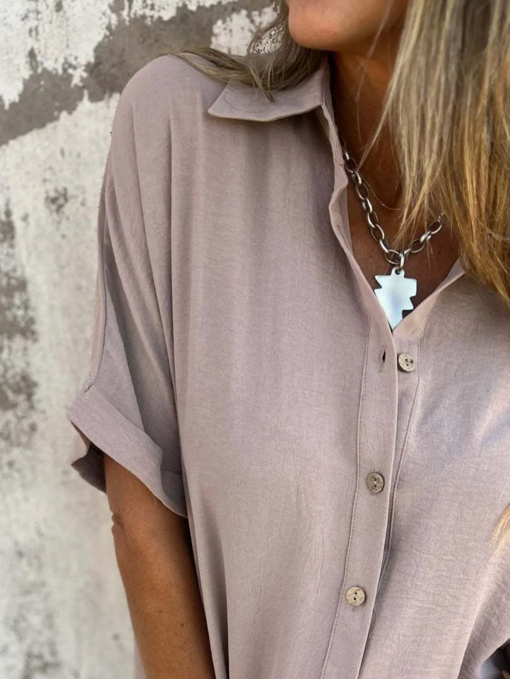 Women's collared half sleeve button-down blouse by Trendsi, showcasing a sophisticated office top with a tailored fit and classic design.