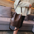 Chocolate croc leather Blake shoulder bag by LadyShow.Store with a sleek design and adjustable strap.