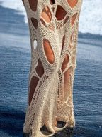 Cutout halter neck cover-up dress from Trendsi, featuring a stylish design with cutouts and a halter neckline.