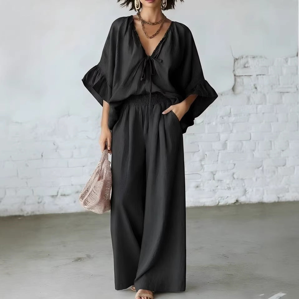 Women's loose-fit V-neck top and wide-leg pants casualwear set by FitiqueFit, featuring comfortable relaxed-fit fabric.